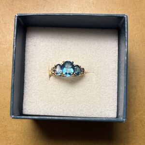 3 genuine oval cut Swiss Blue Topaz stones with 10k yellow gold Ring